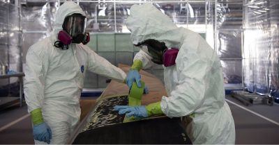 Image of workers preparing a surface for coating