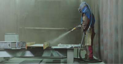 image of a worker sandblasting
